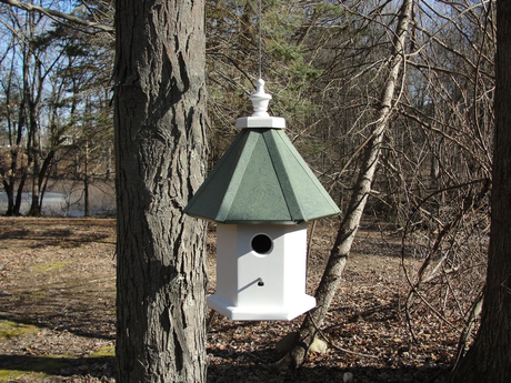 Handmade wooden hanging birdhouse featuring a single nesting compartment, aluminum roof, and vinyl-coated hanging wire for easy installation.