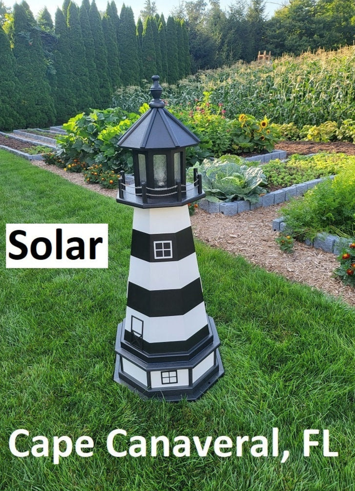 May include: A black and white striped lighthouse with a black roof and a solar panel on top. The lighthouse is standing on a green grassy lawn. The text &#39;Solar&#39; is visible in the image. The text &#39;Cape Canaveral, FL&#39; is also visible in the image.