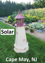 May include: A white and red lighthouse shaped solar light with the words &#39;Solar&#39; and &#39;Cape May, NJ&#39; printed below it. The lighthouse is sitting on a green grassy surface.