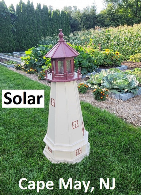 May include: A white and red lighthouse shaped solar light with the words &#39;Solar&#39; and &#39;Cape May, NJ&#39; printed below it. The lighthouse is sitting on a green grassy surface.