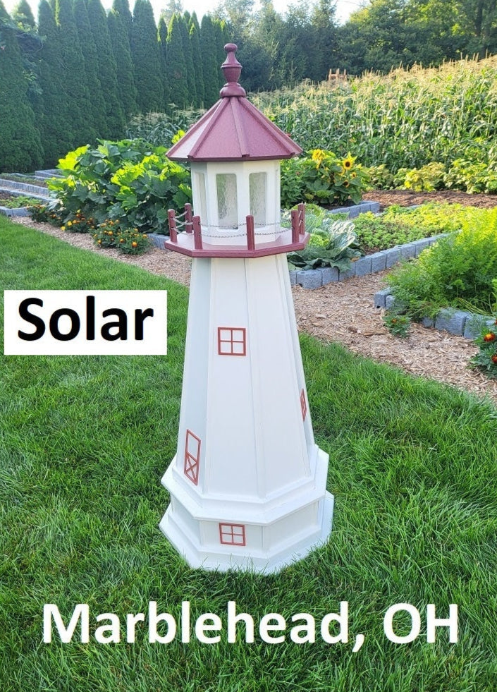 May include: A white and red solar powered lighthouse with a red roof and windows. The lighthouse is on a grassy lawn with the words &#39;Solar&#39; and &#39;Marblehead, OH&#39; printed below it.