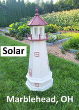 May include: A white and red solar powered lighthouse with a red roof and windows. The lighthouse is on a grassy lawn with the words &#39;Solar&#39; and &#39;Marblehead, OH&#39; printed below it.