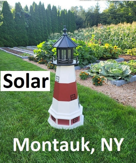 May include: A white and red lighthouse with black trim and a black solar panel on top. The lighthouse is in a grassy area with a garden in the background. The text &#39;Solar&#39; and &#39;Montauk, NY&#39; is visible in the image.
