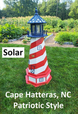 May include: A red, white, and blue lighthouse with a solar powered light. The lighthouse is painted with red and white stripes and has a blue roof. The lighthouse is labeled &#39;Solar&#39;, &#39;Cape Hatteras, NC&#39;, and &#39;Patriotic Style&#39;.
