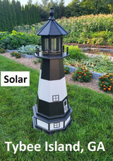 May include: A black and white lighthouse with a solar panel on top. The lighthouse is standing on a green lawn with a garden in the background. The text &#39;Solar&#39; is visible on the left side of the image. The text &#39;Tybee Island, GA&#39; is visible at the bottom of the image.