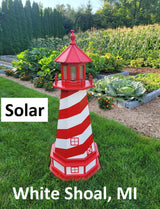 May include: A red and white striped lighthouse with a solar light. The lighthouse is in a garden setting with green grass and plants. The text &#39;Solar&#39; and &#39;White Shoal, MI&#39; are visible in the image.